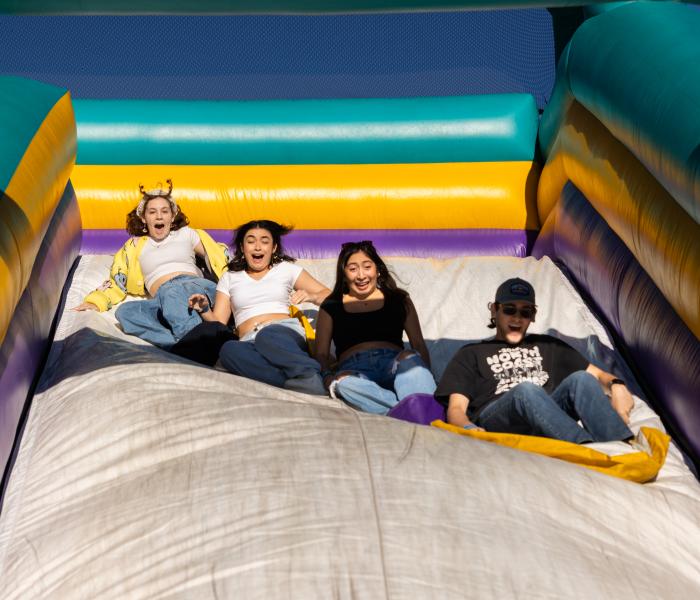 Students having fun at inflatable slide