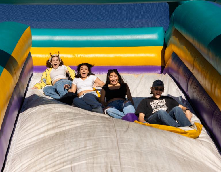 Students having fun at inflatable slide
