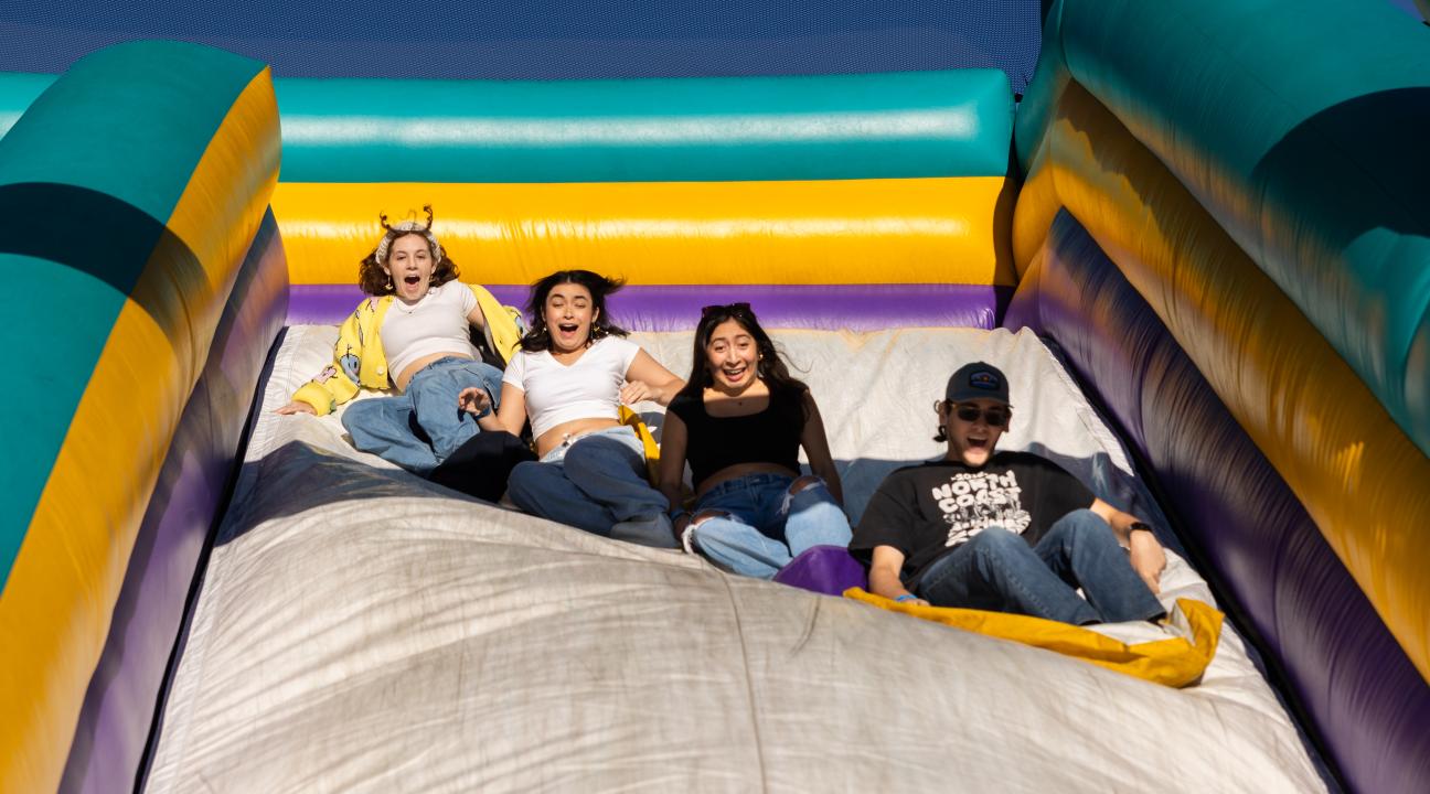 Students having fun at inflatable slide