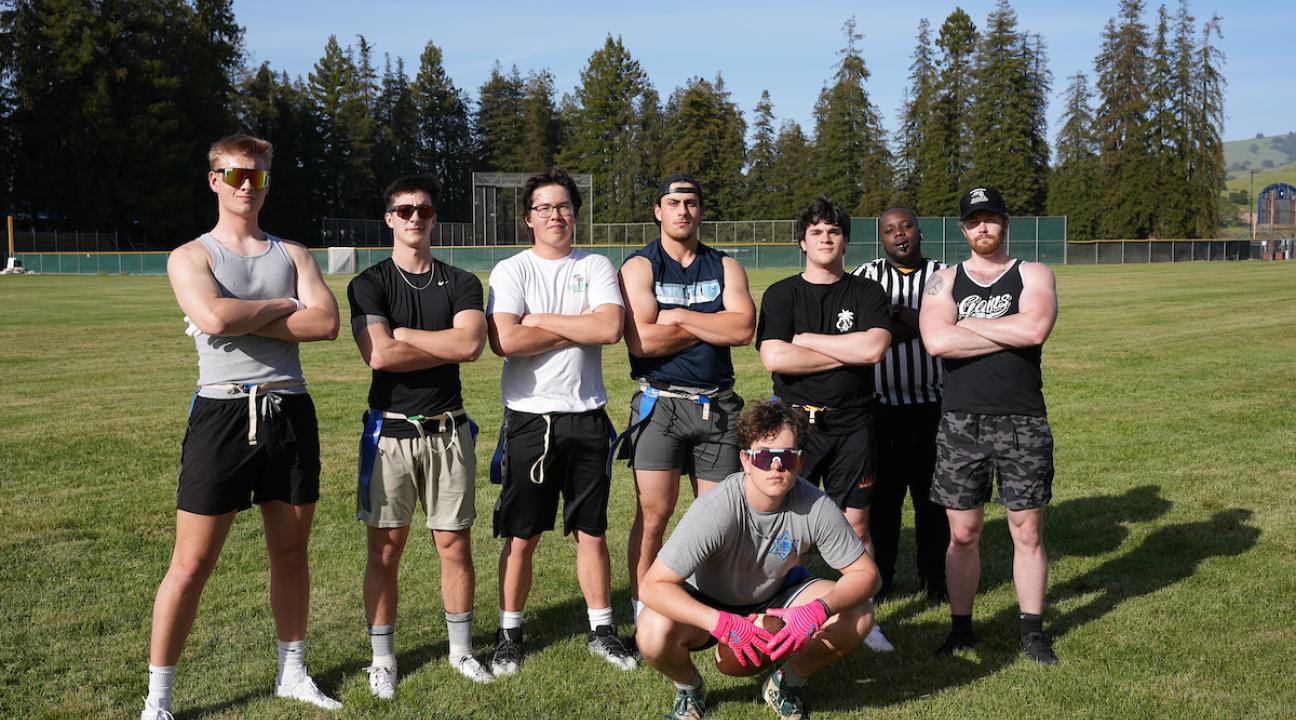 a group of male students standing on a field