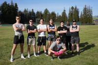 a group of male students standing on a field