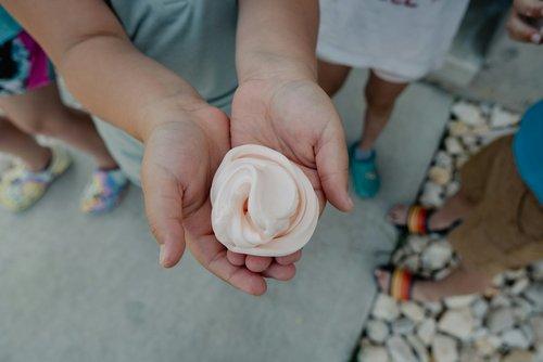 two hands holding a gooey ball of slime