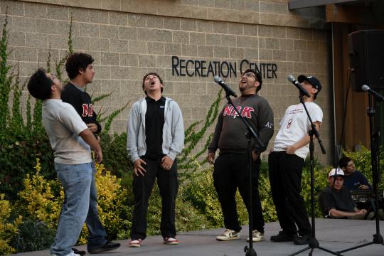 Fraternity students singing on stage at seawolf plaza