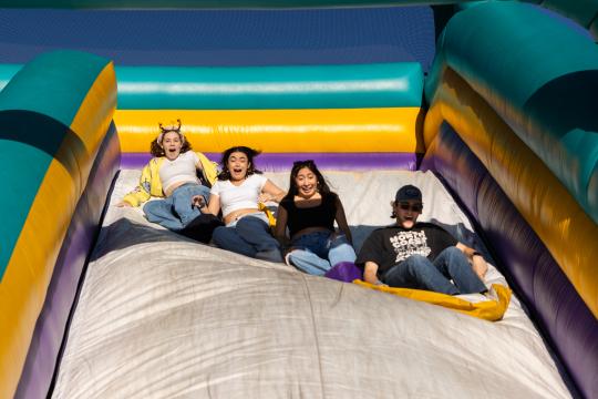Students having fun at inflatable slide
