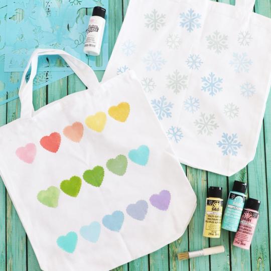 DIY Painted Tote Bags on a blue surface