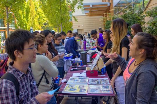 Photo of people mingling at club fair 