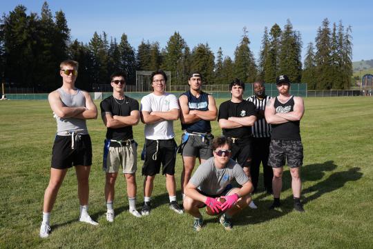 a group of male students standing on a field