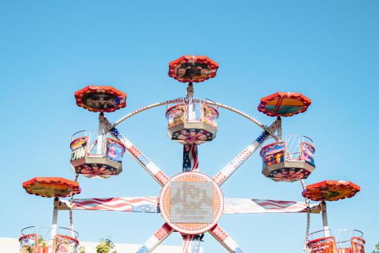 a fair ride against a blue sky