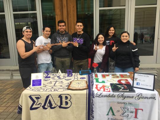 a fraternity and a sorority tabling side by side