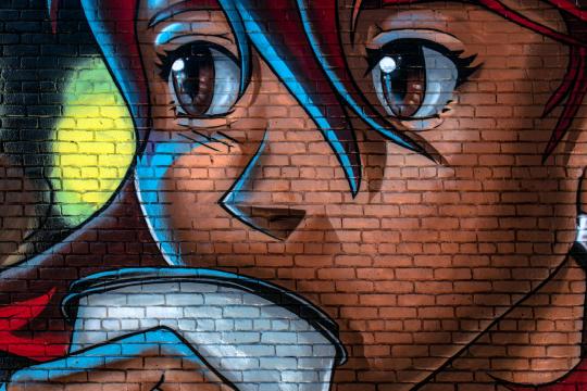 Photo of Anime on a Brick Wall